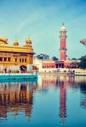Vintage retro effect filtered hipster style image of famous indian toursit landmark and sacred pilgrimage site - Sikh gurdwara Golden Temple (Harmandir Sahib). Amritsar, Punjab, India