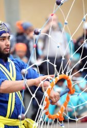 SAN GIOVANNI VALDARNO, ITALY - APRIL 15, 2014: NagarKirtan, Indian religious procession celebrated in different parts of Italy and the world. All participants wear traditional dress and turban with the emblem of the Sikh faith.