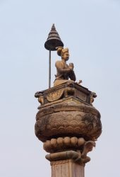 The statue of King Bhupatindra Malla with a blue sky in the background, Durbar Square, Bhaktapur, Nepal